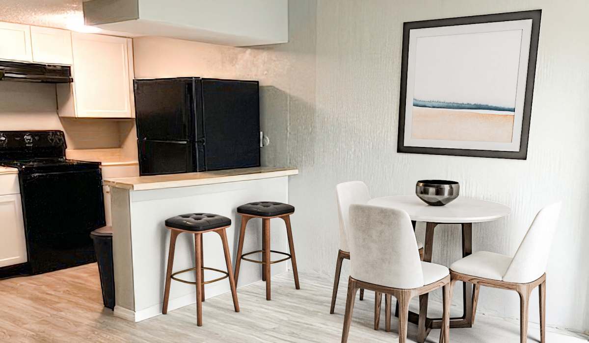 Living room space with study table and kitchen view at Cliffside at Mountain Park in El Paso, Texas